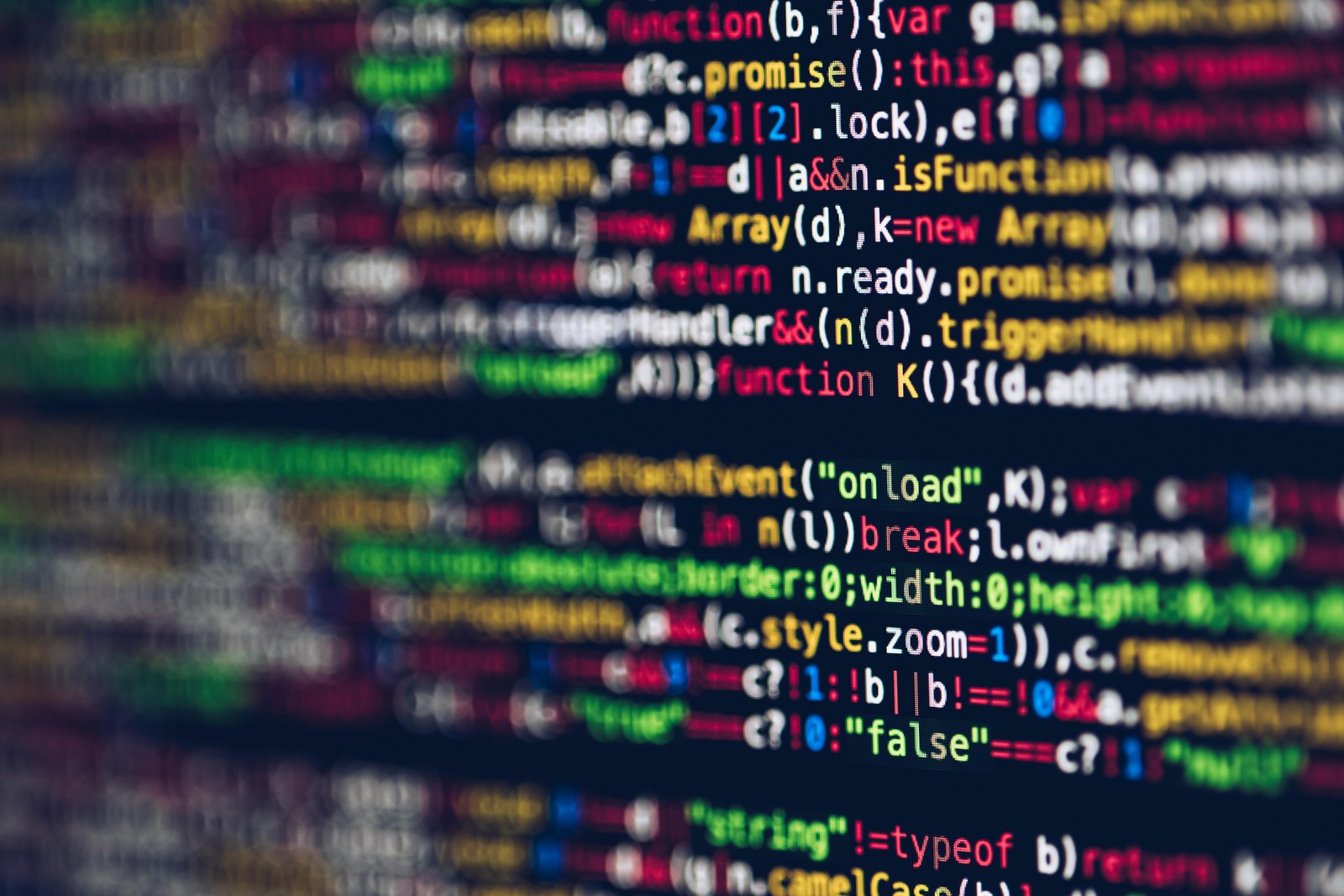 Home Vivid, blurred close-up of colorful code on a screen, representing web development and programming.